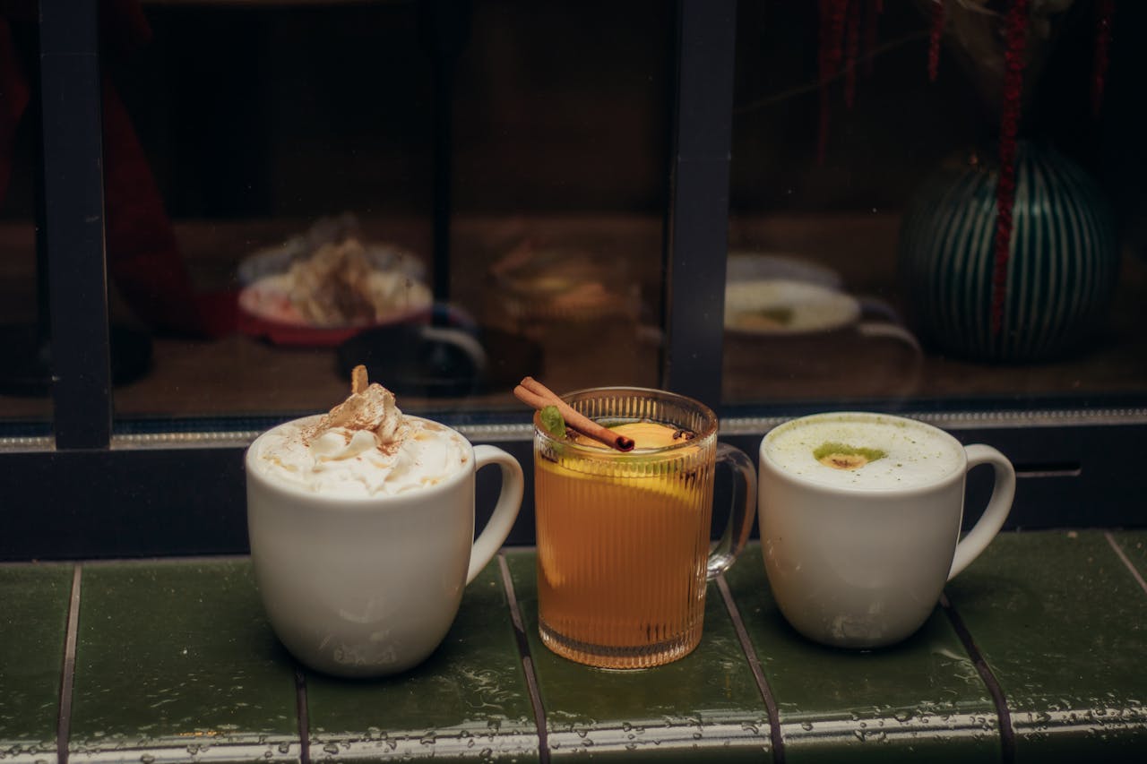 home-hero Three cozy hot drinks sit on a rainy windowsill, creating a perfect autumn vibe.